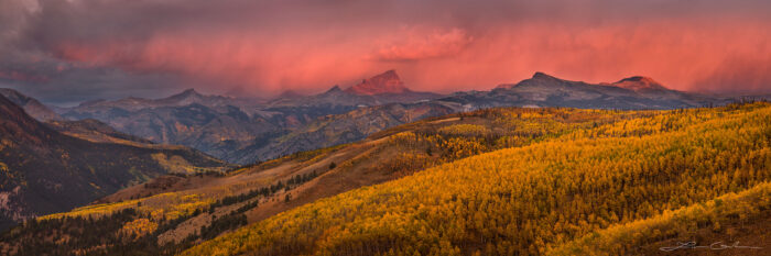 Yellow aspen hills and Uncompahgre Peak with pink clouds at sunrise
