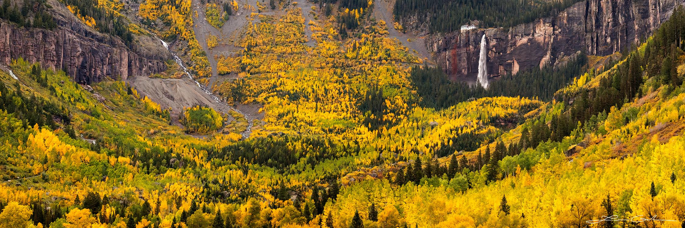 Valley of golden yellow aspens and a big waterfall near Telluride