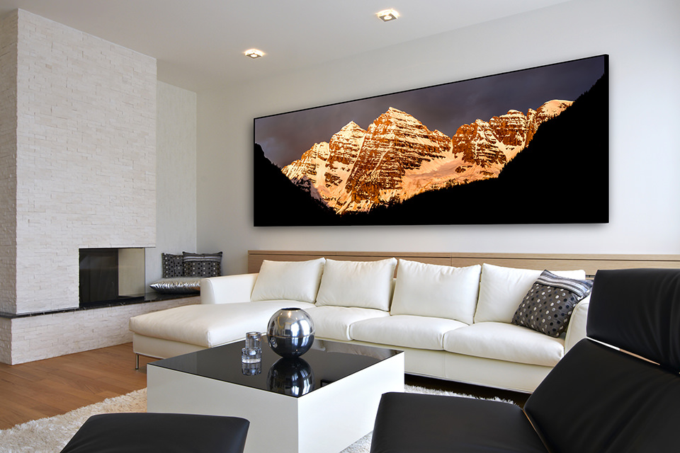 Panoramic fine art print of Maroon Bells on a wall in a contemporary home living room