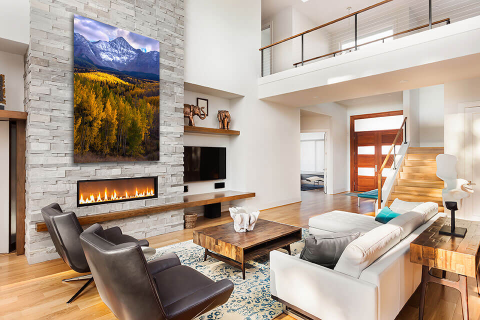 Interior design with Gintchin Fine Art print of fall colors in the mountains above a modern fireplace in a contemporary home