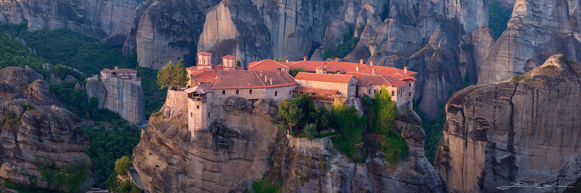 A monastery atop a tall cliff, surrounded by other tall cliffs, Meteora, Greece