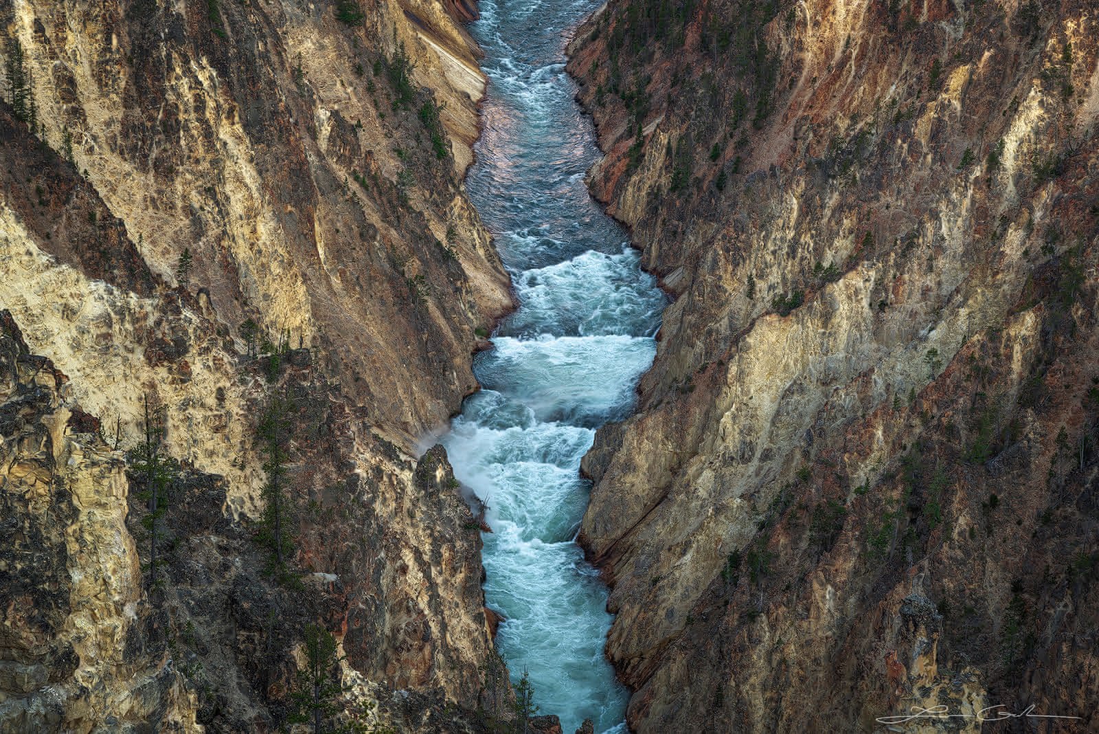 A blue river flowing through a narrow and steep canyon, Yellowstone National Park