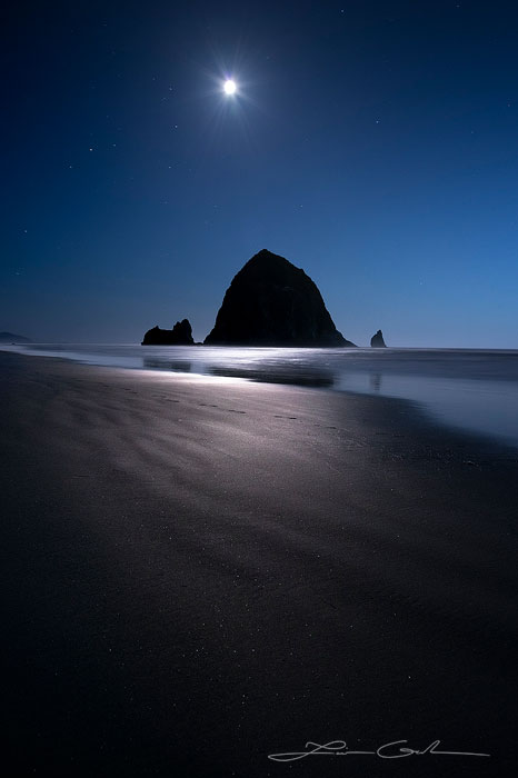 Night moon shining over a big pointed rock and the ocean beach, Oregon - Small