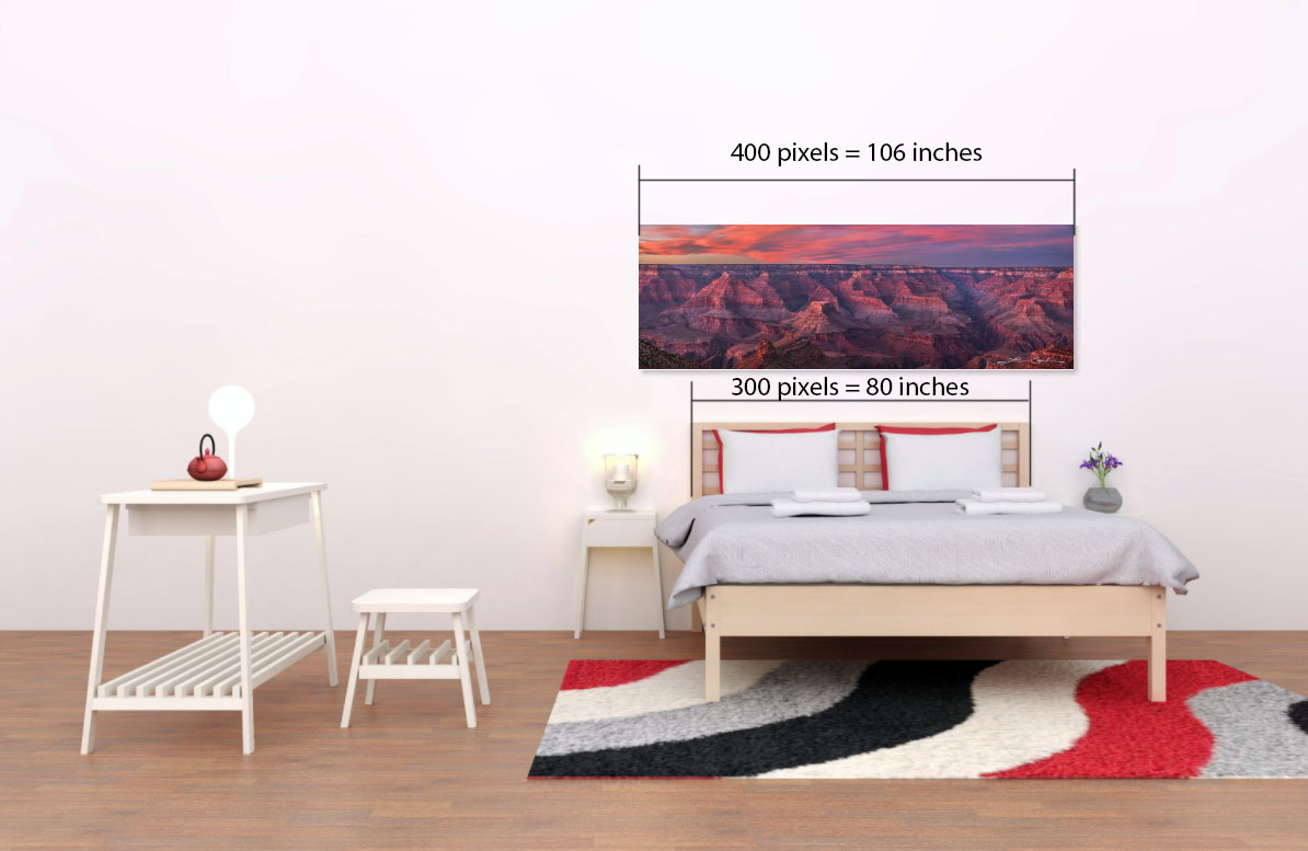 A bedroom with a fine art image above and size measurements