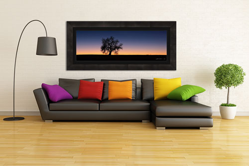 A contemporary living room with a couch and a panoramic framed print above it for interior design - Small