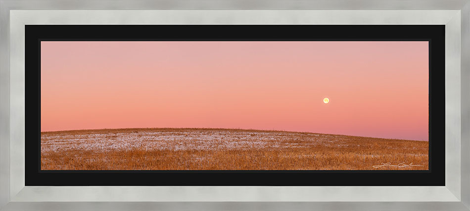 A full moon print, framed in a grey frame and a black liner