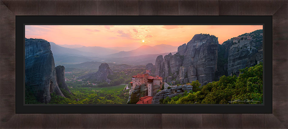 A framed print of Meteora Greece with a sunset and monasteries - black liner