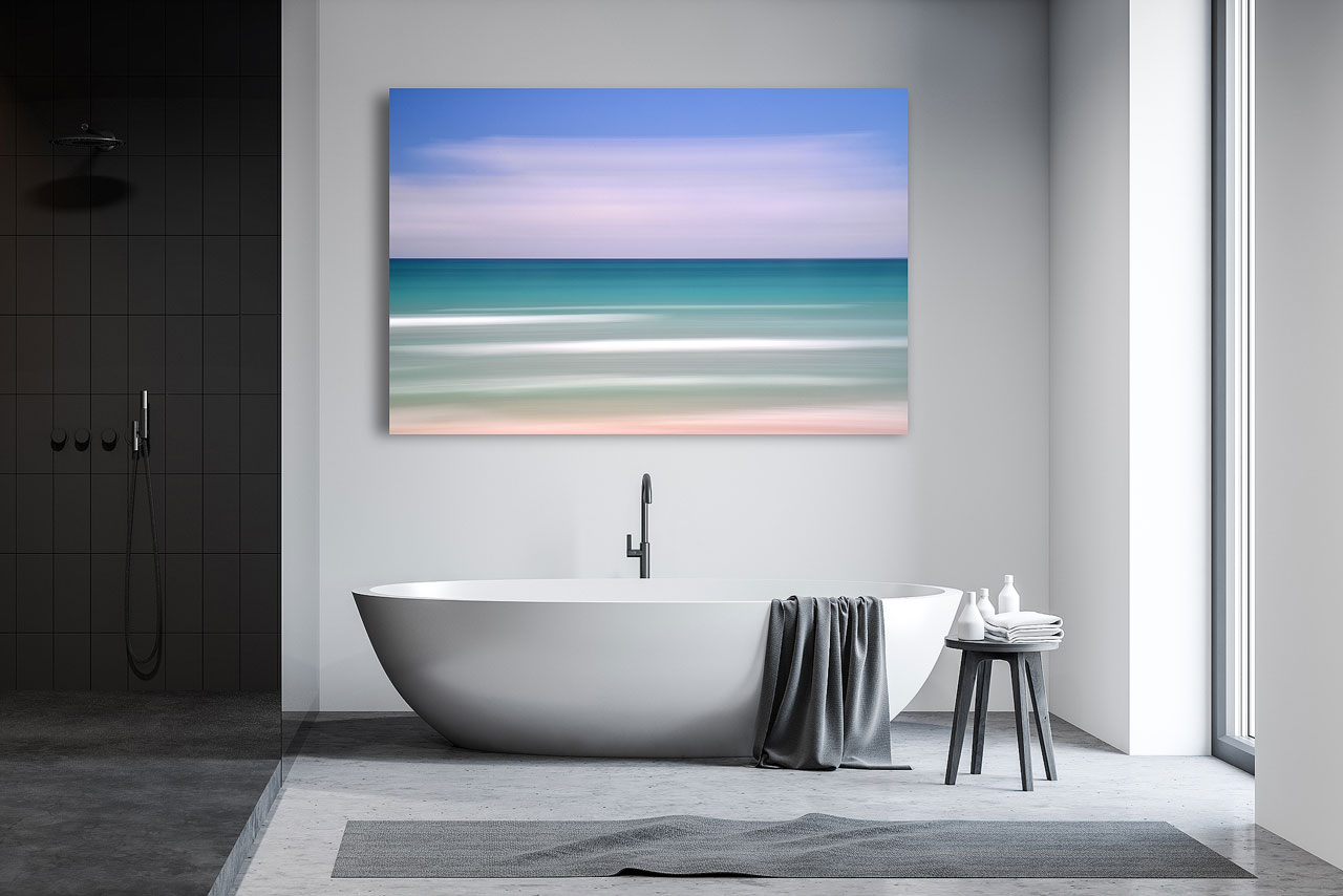Interior design with fine art photography showcases a large abstract wall art print of the ocean inside a modern bathroom - Gintchin Fine Art