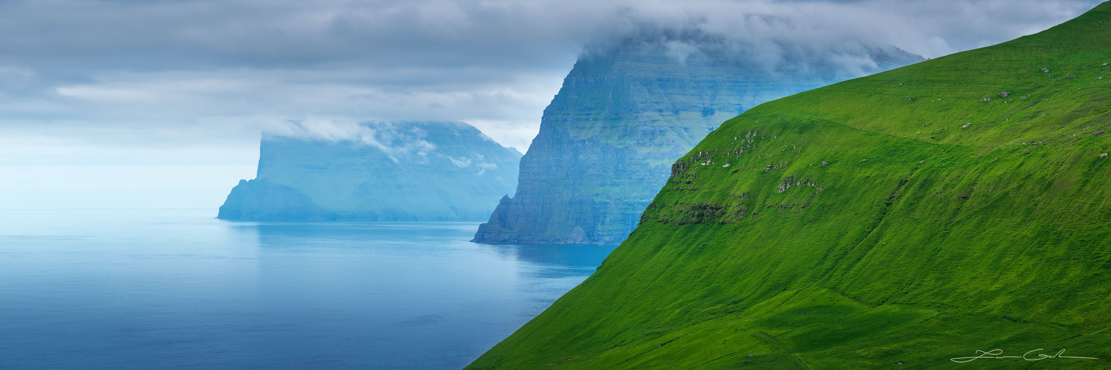 Steep rock wall mountain islands with lots of green grass - Faroe Islands - Gintchin Fine Art