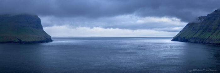 A panoramic photograph with an ocean outlet between two islands - Faroe Islands - Gintchin Fine Art