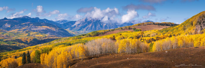 A Colorado wilderness bursting with fall colors and mountains in the background - Gintchin Fine Art