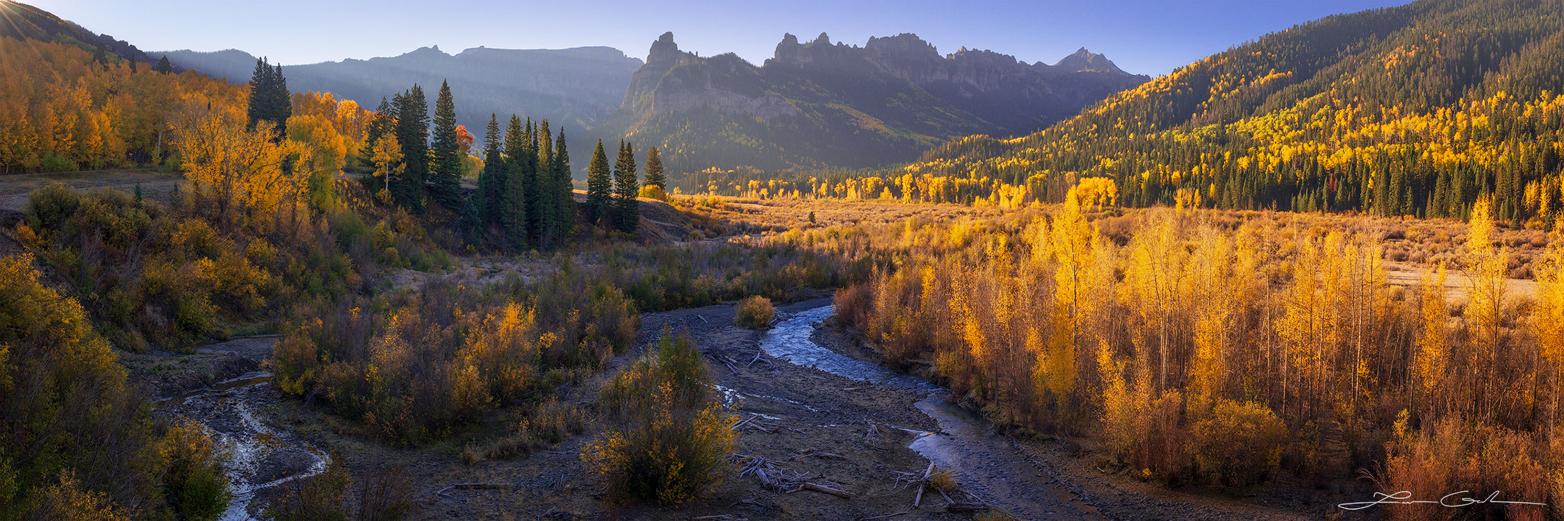 A mountain valley fill with yellow aspen trees and a river - Gintchin Fine Art