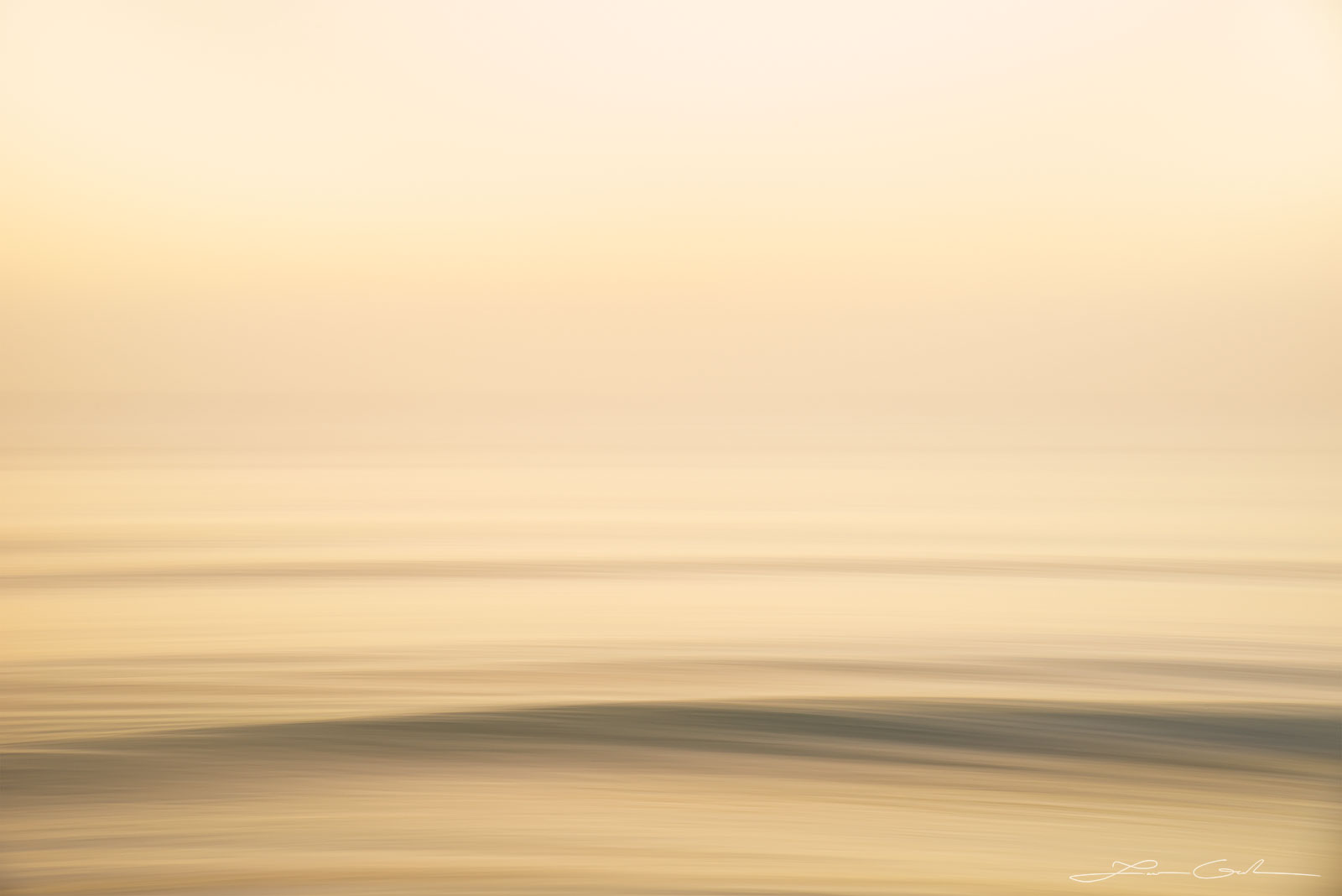 Smooth and gentle waves during yellow morning sunlight abstract photo - Gintchin Fine Art