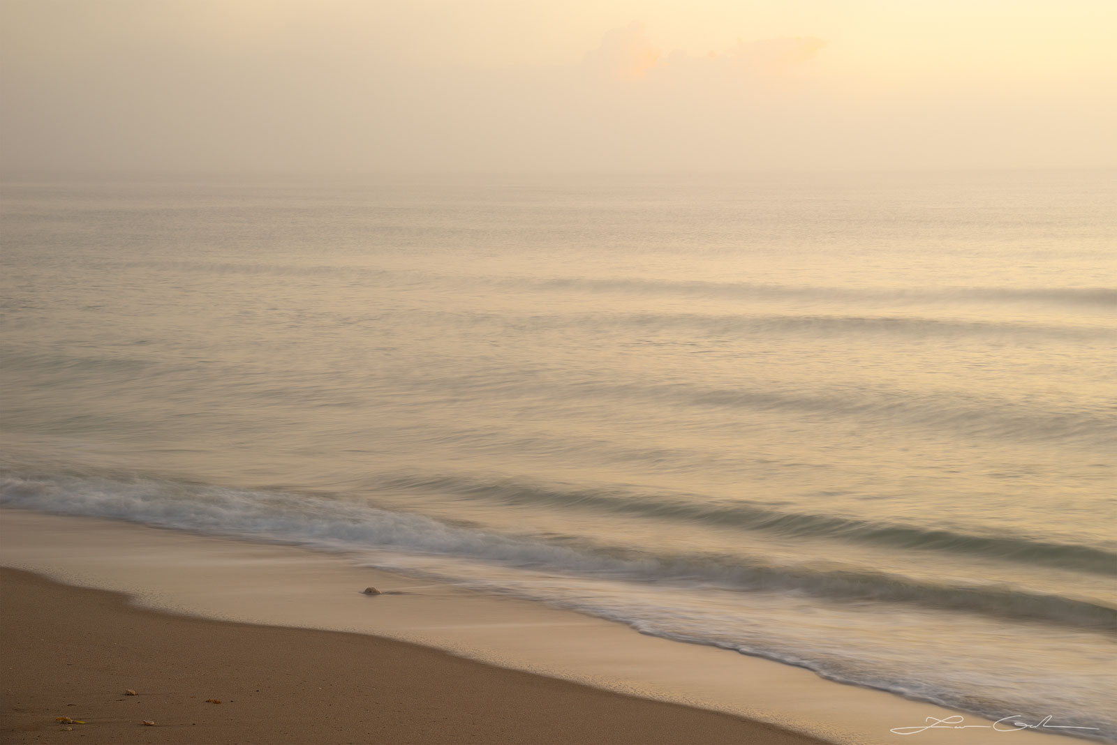 Gentle ocean during morning light and a sandy beach shore - Gintchin Fine Art