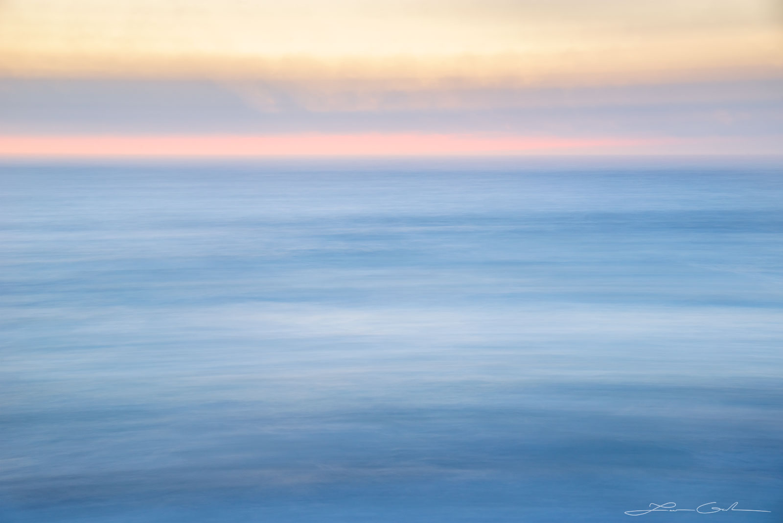 Blue sea abstract photo at sunrise with some pink on the horizon - Gintchin Fine Art
