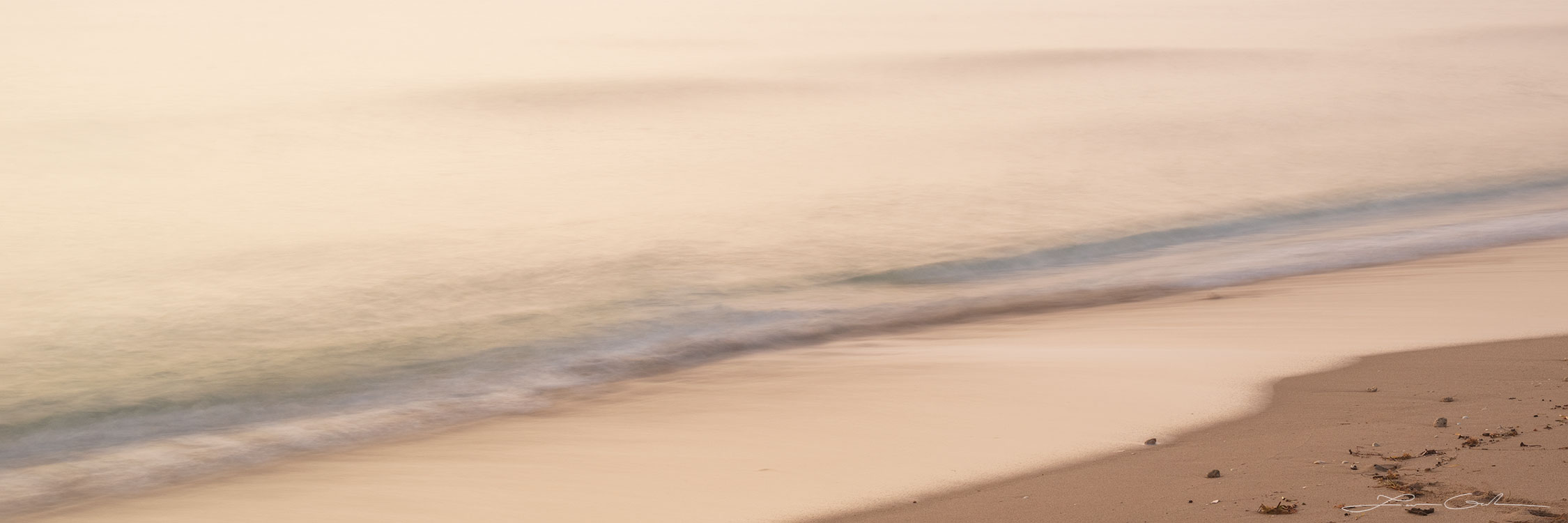 A peaceful shore close-up with some sand and a small wave - Gintchin Fine Art