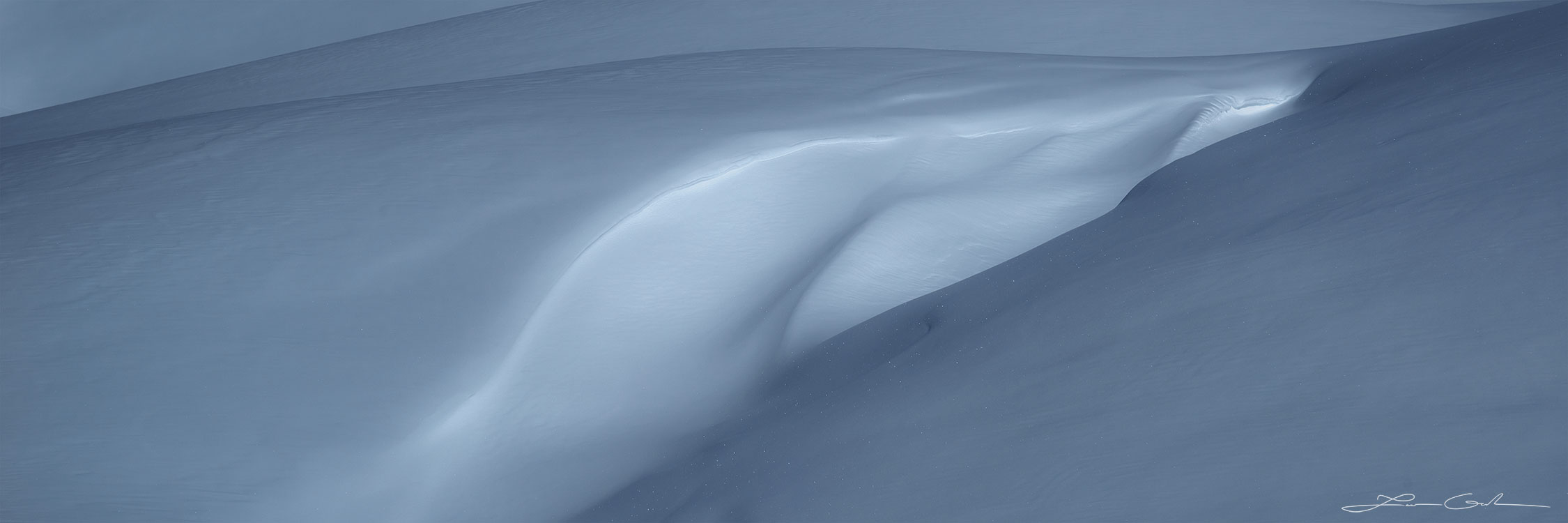 Abstract winter light on wind-swept snow formations during winter - Gintchin Fine Art