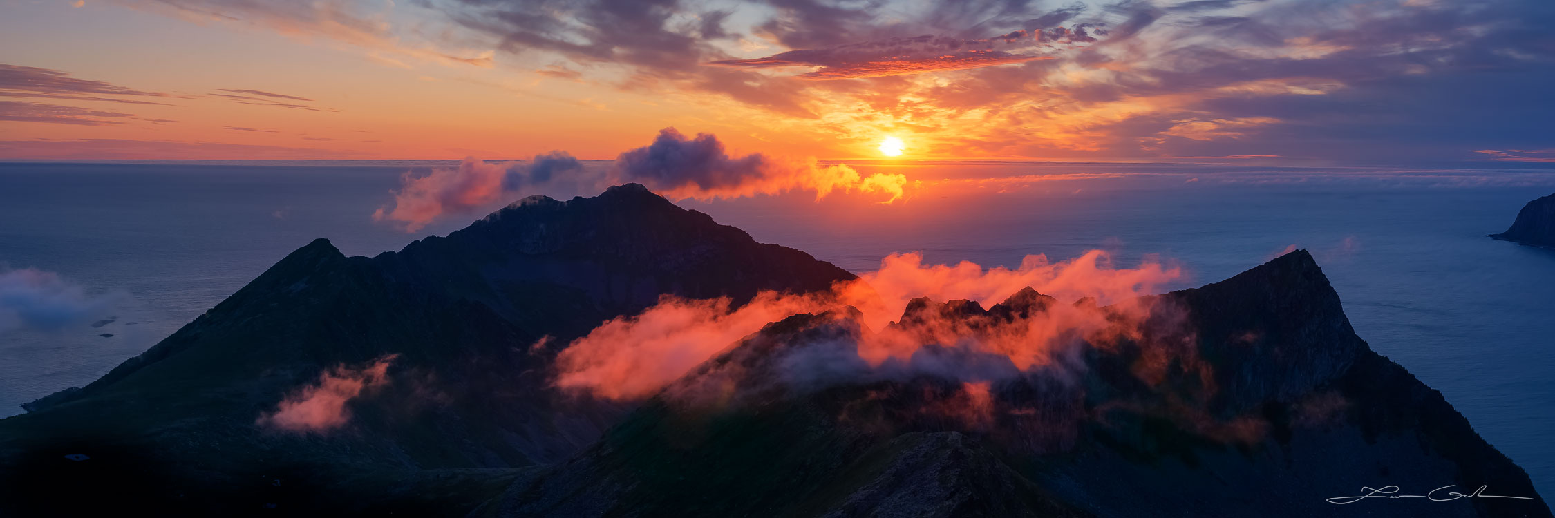 A dramatic panoramic sunset Norway with mountains, red clouds, and ocean - Gintchin Fine Art