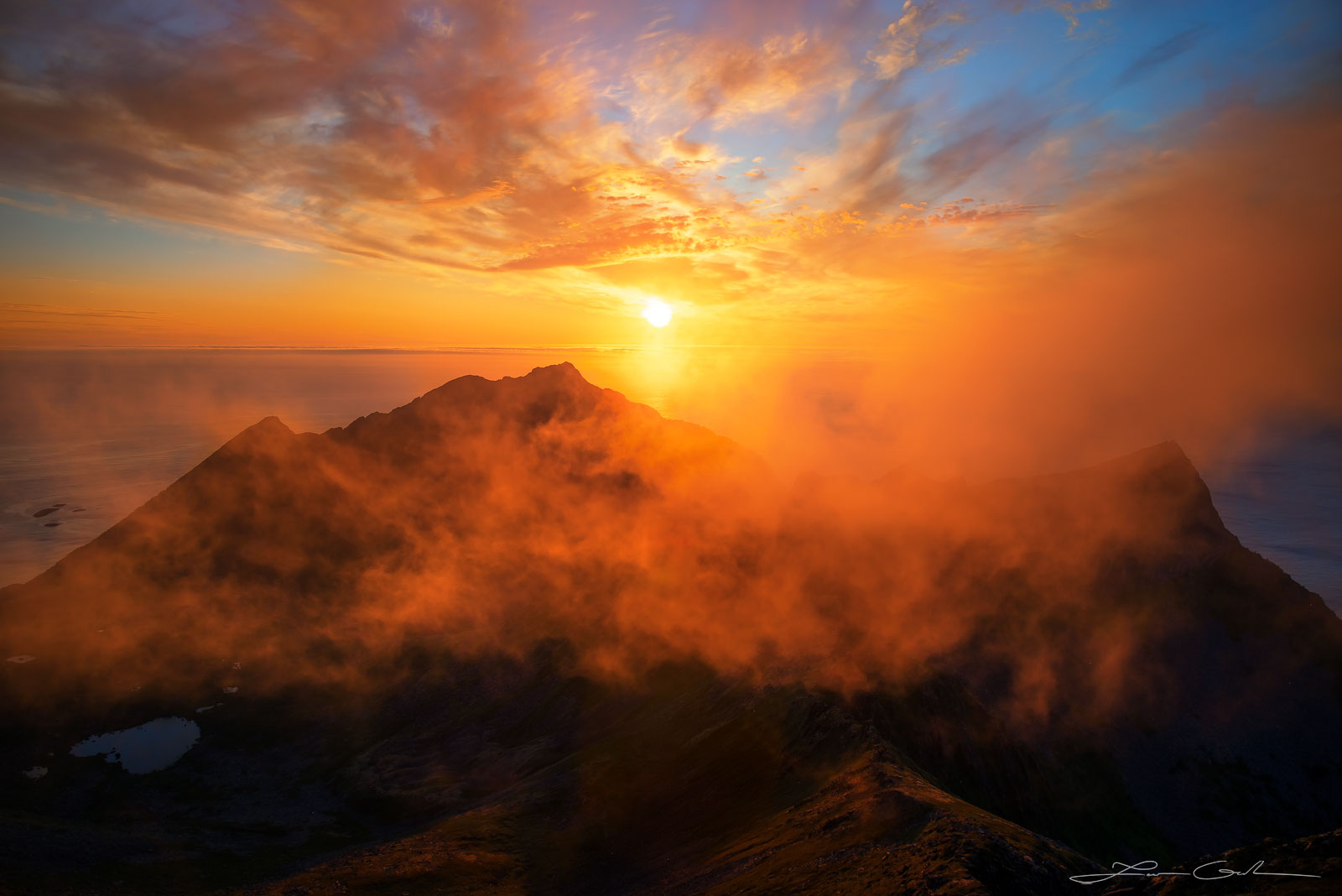 A dramatic sunset with fog, clouds, and orange light in Northern Norway - Gintchin Fine Art