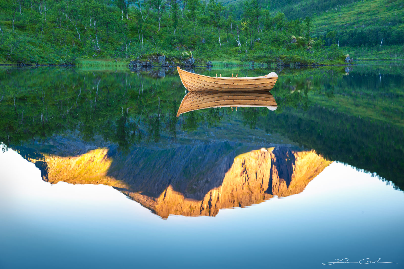 A calm lake boat reflection with a sunrise mountain in Norway - Gintchin Fine Art