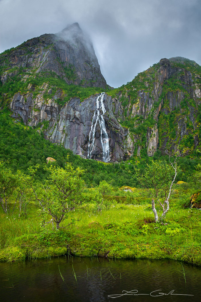 A double waterfall in the Lofoten Islands, Norway in a lush green mountainous setting - Gintchin Fine Art