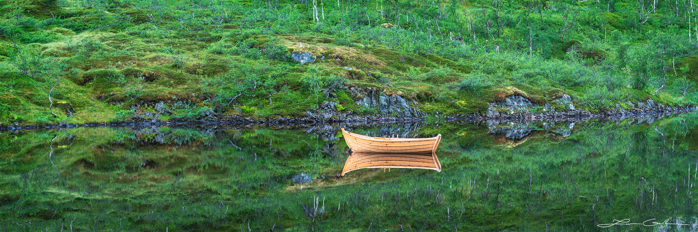 A beautiful solitary boat reflects in a calm lake - Gintchin Fine Art