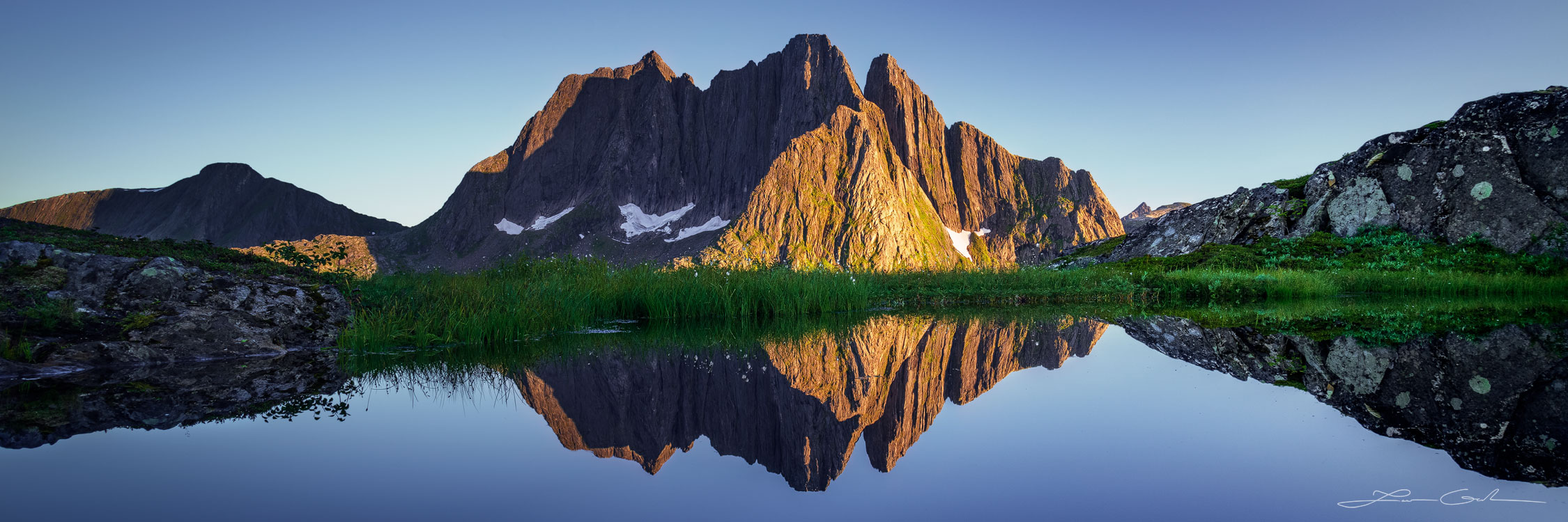 A beautiful mountain lake reflection panorama at sunset in Norway - Gintchin Fine Art