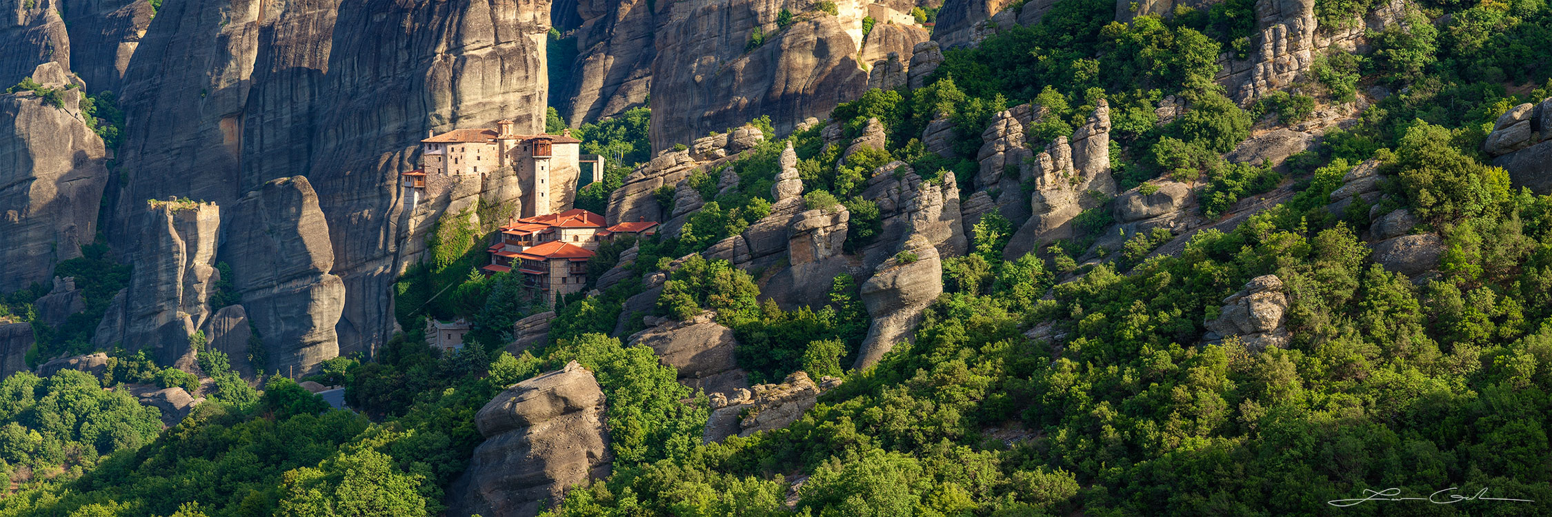 A panorama of Meteora, Greece featuring the Roussanou Monastery and lots of rocks and vertical walls - Gintchin Fine Art