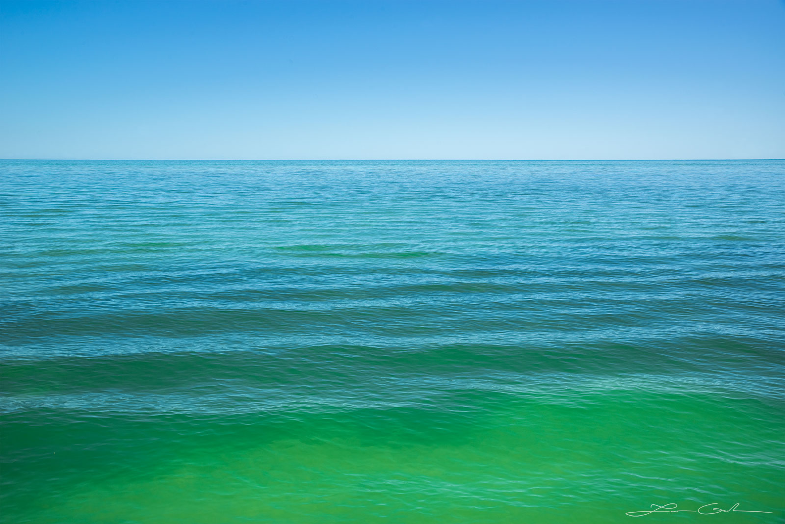 A minimalist image of a calm turquoise ocean and clear skies in the Florida Keys - Gintchin Fine Art