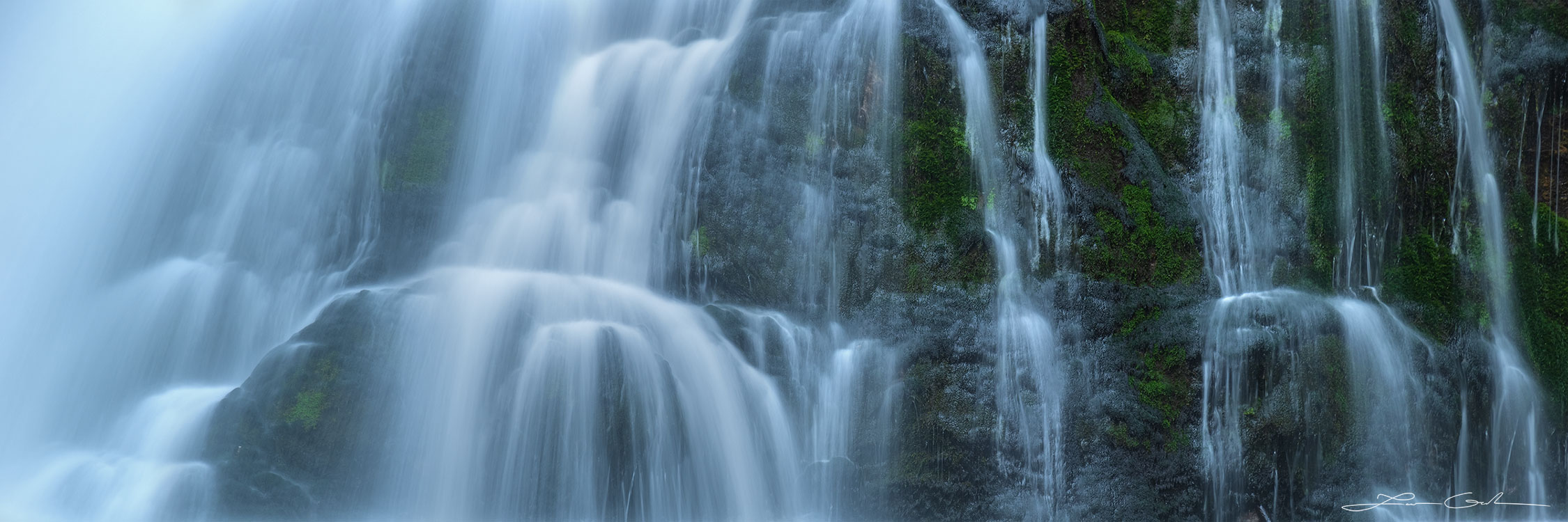 A close up of a cascading waterfall with gentle silky water from the slow motion shot - Gintchin Fine Art