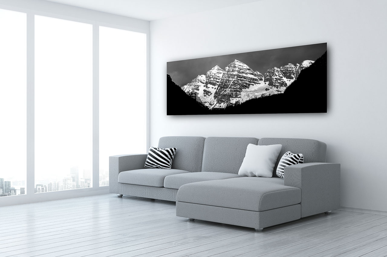 A black and white panoramic print of Maroon Bells, Colorado in a living room - Gintchin Fine Art