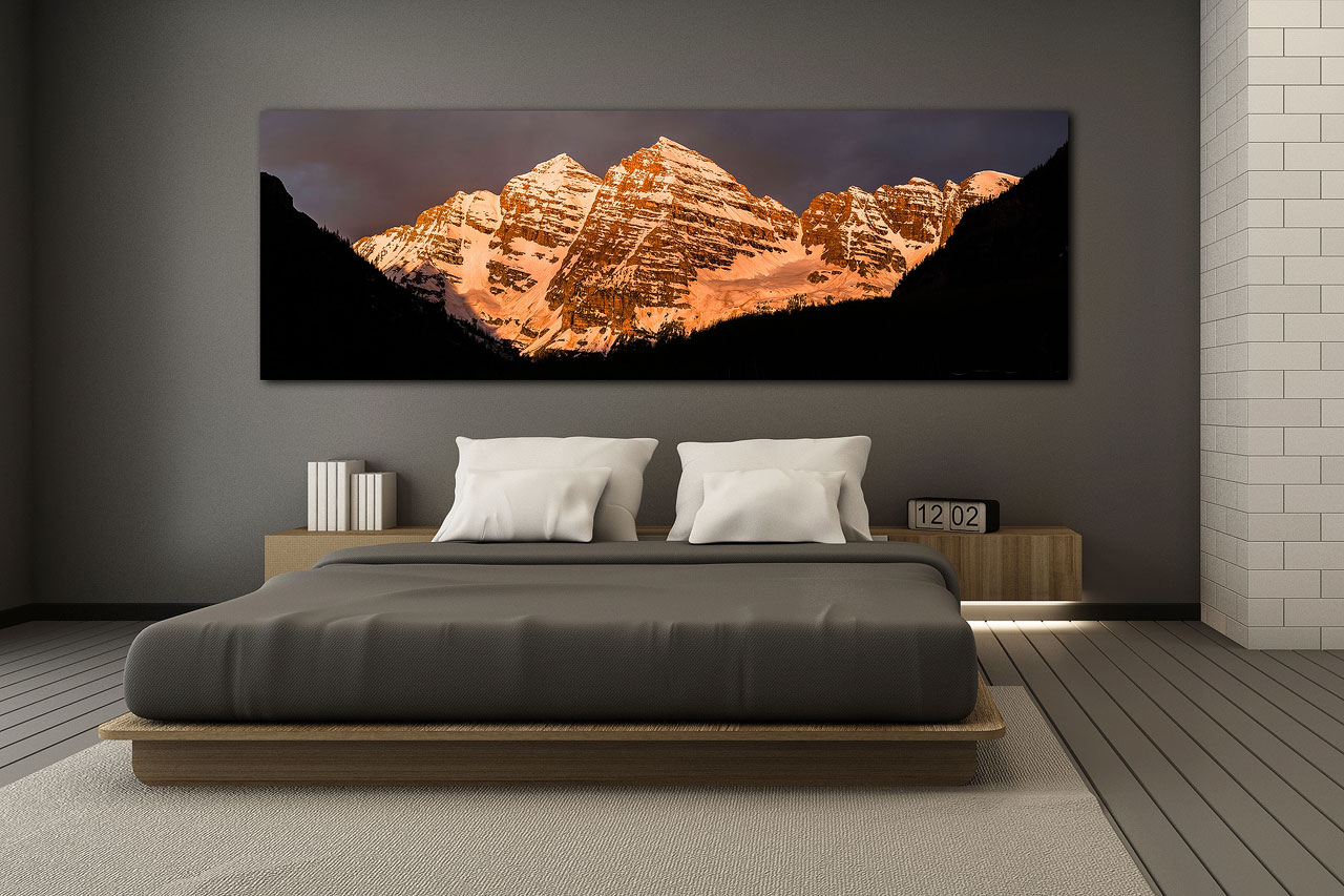 A panoramic large format print of Maroon Bells, Colorado in a modern bedroom - Gintchin Fine Art