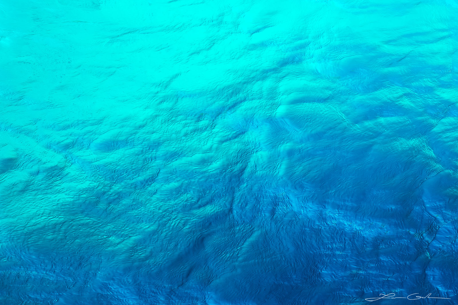 Close-up image of turquoise ocean water, showcasing vibrant color and captivating textures, capturing the essence of the ocean's luminescence - Gintchin Fine Art.