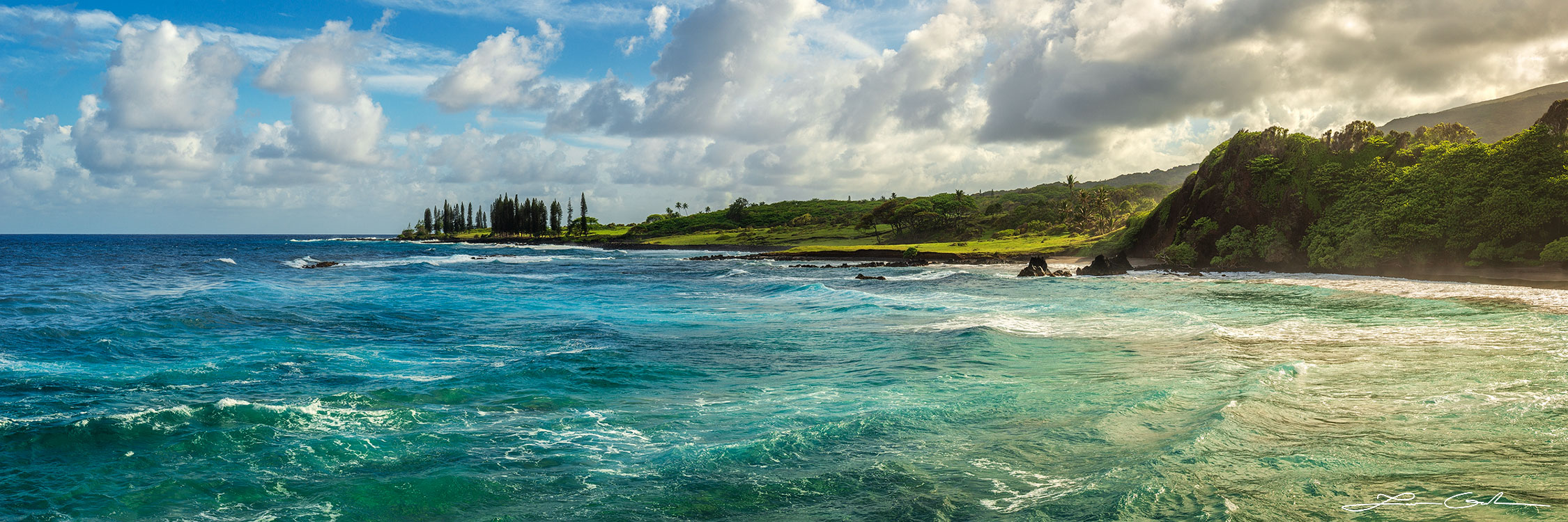Panorama of an animated ocean bay in Hawaii with a distant isthmus under a setting sun, capturing a lively sea in deep blues and vibrant turquoise - Gintchin Fine Art