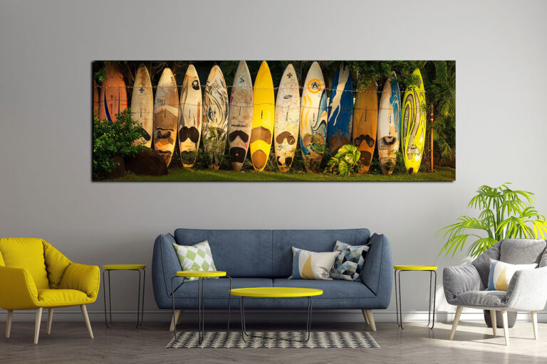 Panoramic luxury wall art print of surfboards in Maui, Hawaii mounted over a sofa in a living room - Gintchin Fine Art