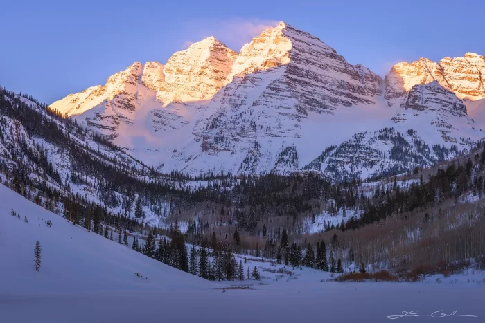 Snow covered Maroon Bells, a quintessential Colorado scene with the morning sun painting the majestic peaks in a divine blaze. - Gintchin Fine Art