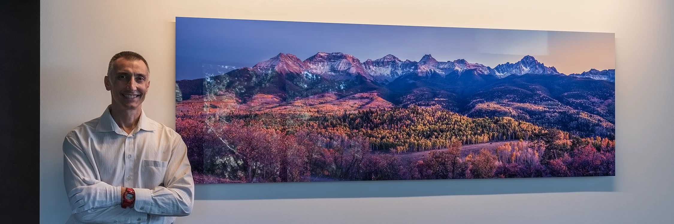 A large size panoramic metal print, of a Colorado mountain range, on a white wall. - Gintchin Fine Art