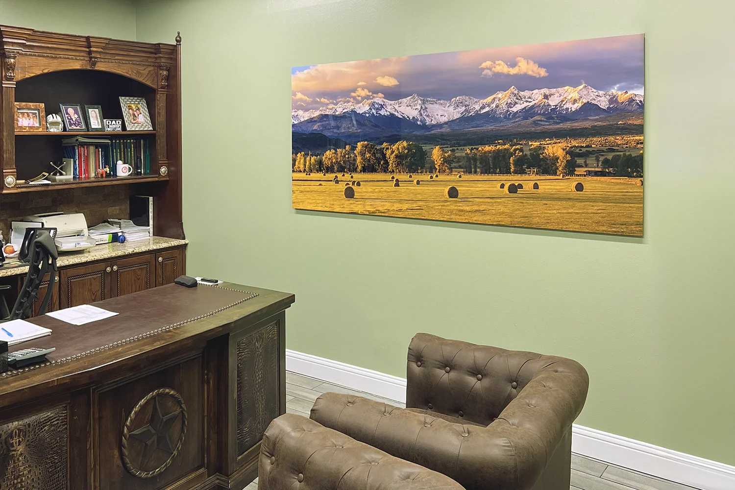 A large panoramic metal print of Colorado in an executive office - Gintchin Fine Art
