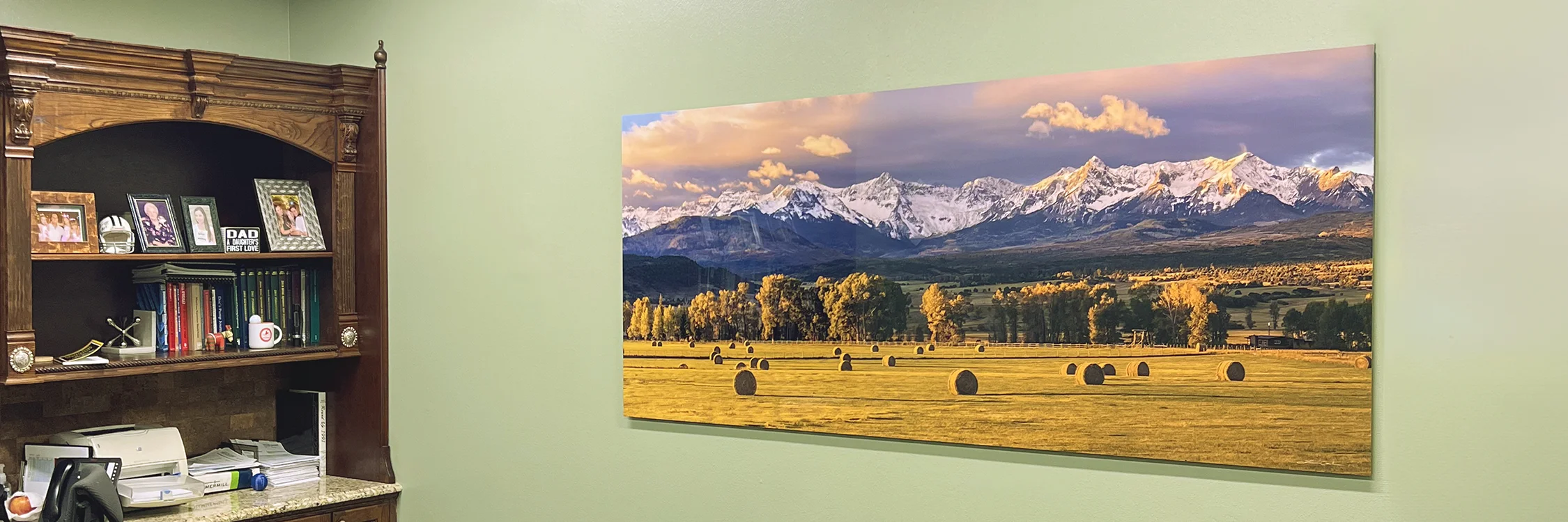 A large panoramic metal print of Southwest Colorado on the wall of an executive office - Gintchin Fine Art