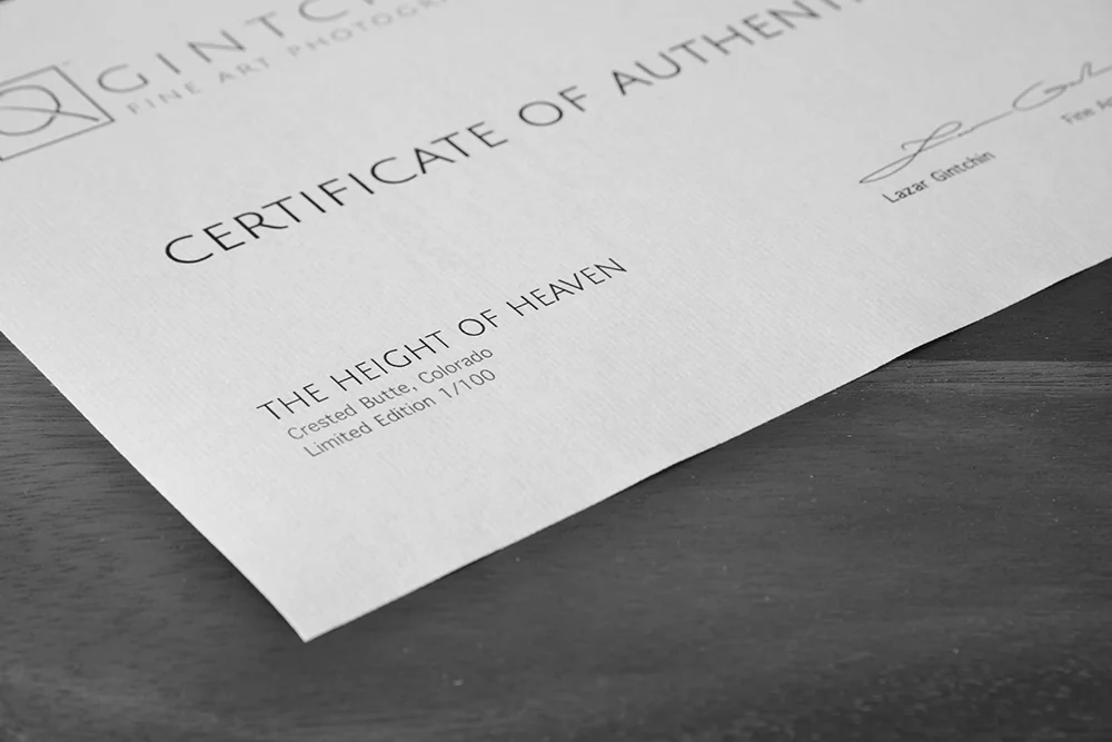 Close-up of a "Certificate of Authenticity" from Gintchin Fine Art, highlighting the artwork's title, "THE HEIGHT OF HEAVEN," location details, and limited edition print details. The text emphasizes authenticity for the artwork.