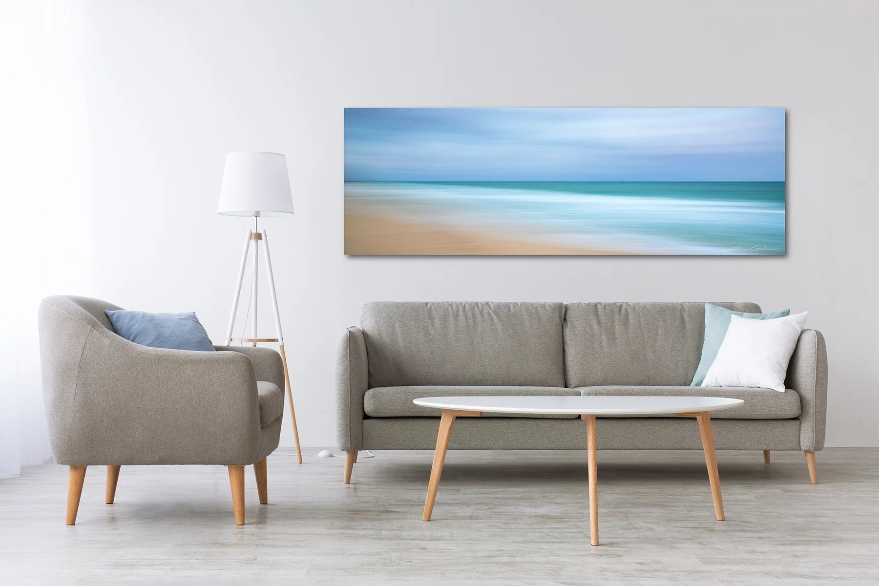 Luxury wall art with a large format ocean abstract fine art print above a sofa, enhancing a modern living room with elegance and sophistication